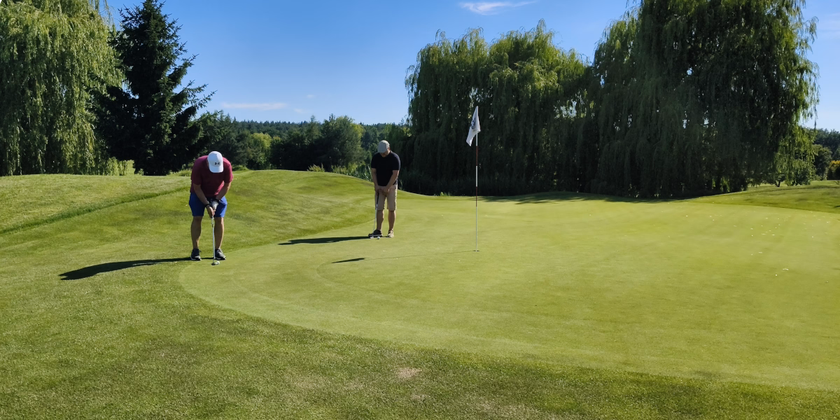 Participants practising putting on the green