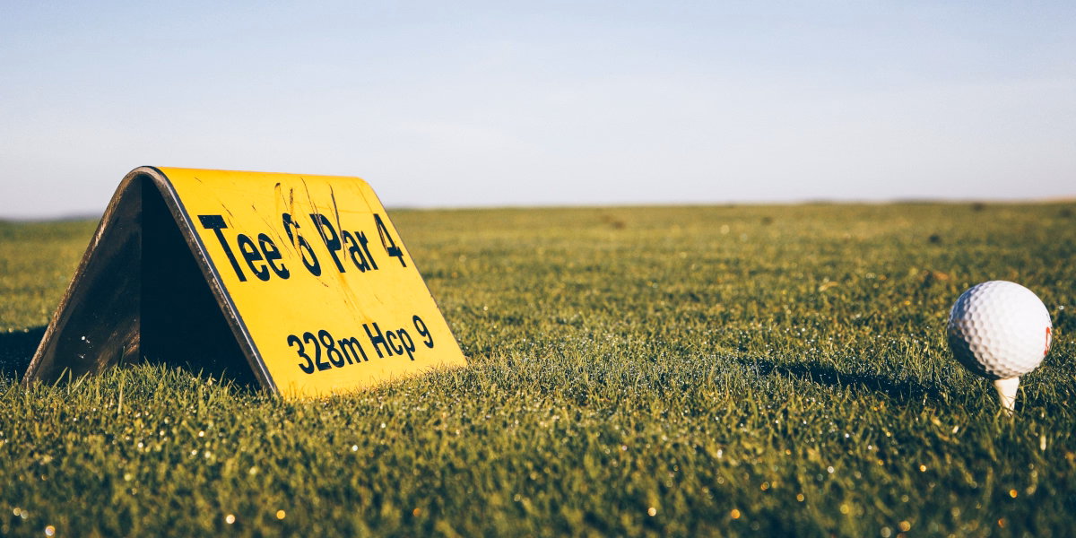 Golfista wybija piłkę z bunkra przy greenie