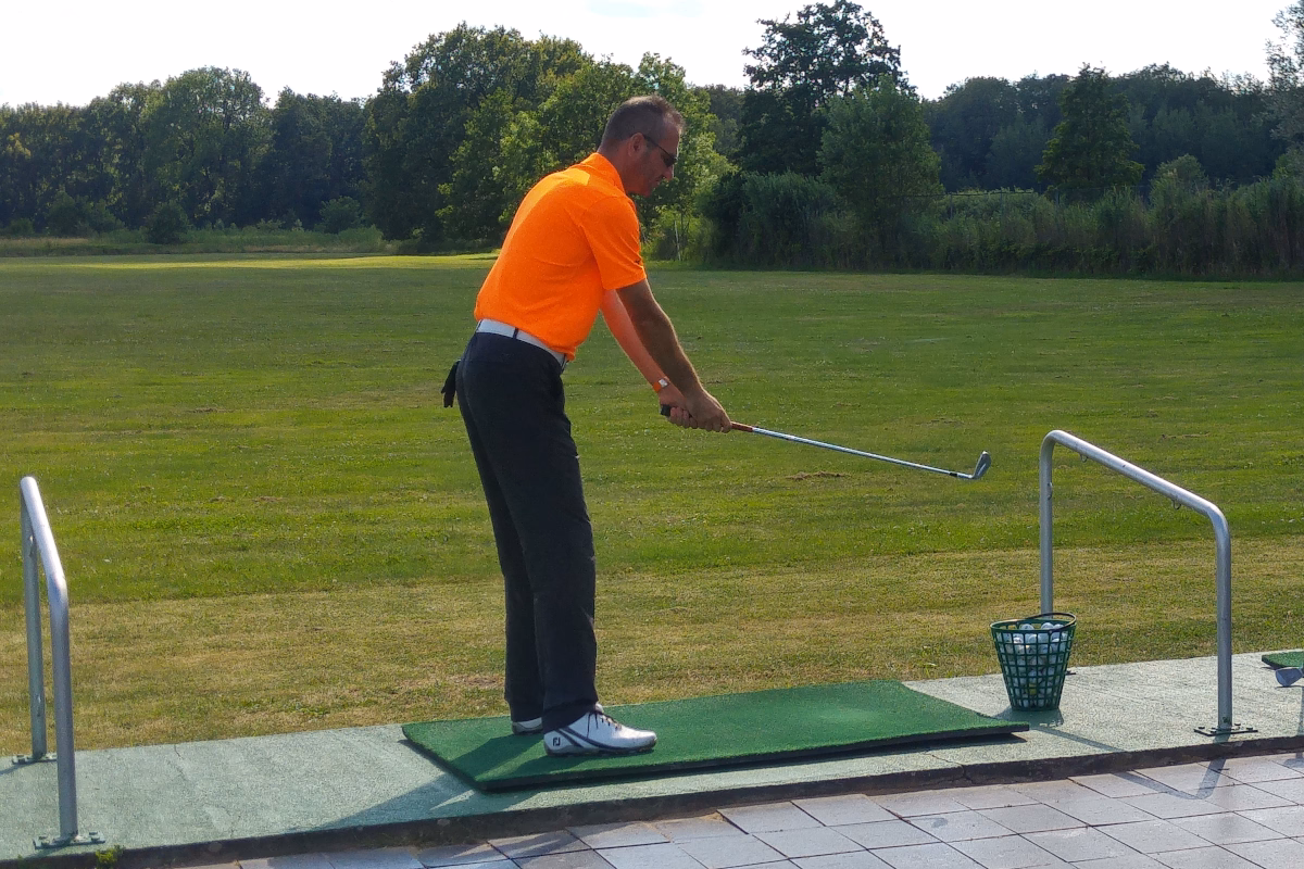 Golf coach demonstrating the setup position